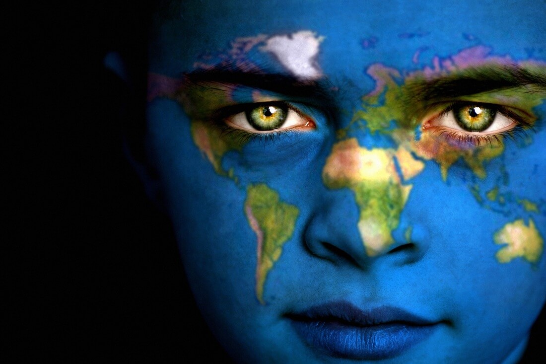 Painting of the world map on a human face for a geography assignment